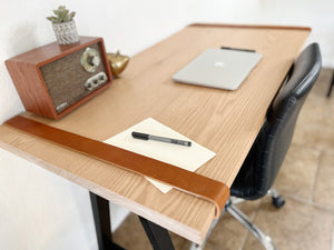 Desk top with woodgrain and leather straps
